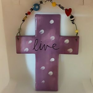 Purple cross with live on it